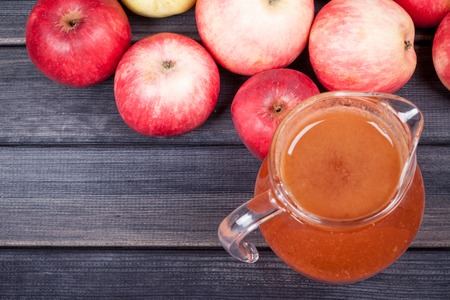 fresh apple juice in the pitcher table close upの写真素材