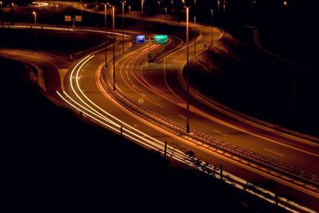 Straight night highway with car's traces