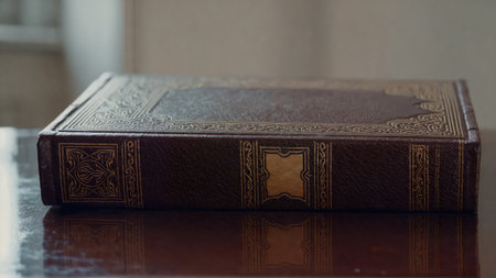Closed vintage book with gold embossed cover on wood Shows history tradition literature learning Quiet study knowledgeの写真素材