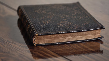 Close view leather tome on polished wood with worn texture Hints at legacy study knowledge wisdom history themeの写真素材