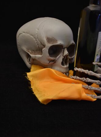 skull looking at the properties of a bottle of Spanish olive oilの写真素材