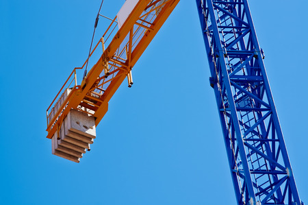 New blue elevating crane with suspension for construction of high buildingsの写真素材