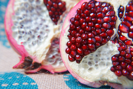 Half a large red pomegranate on linen the tablecloth