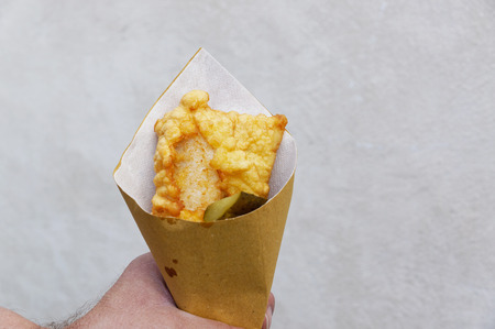 Shrimps, potatoes and vegetables in batter, fried . Street food in cardboard package. Roast, fries...