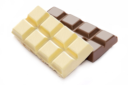 Broken milk and white chocolate bars close upの写真素材