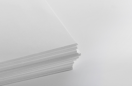 Stack of blank white paper on white backgroundの写真素材