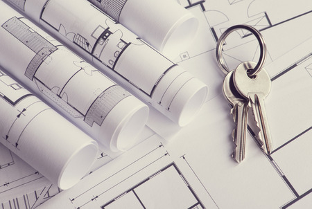 Toned and selective focus image. Bunch of keys on the house plan