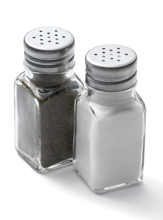 Salt and pepper shakers on a white backgroundの写真素材