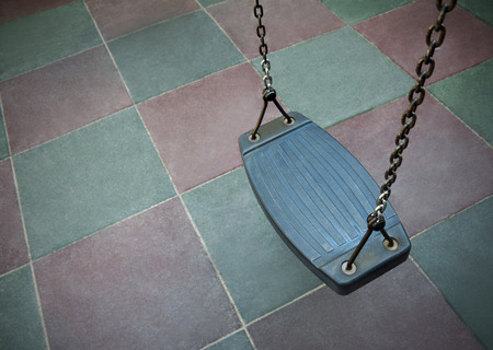 Empty swing on children playgroundの写真素材