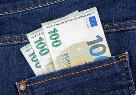 Euro banknotes in the pockets of jeans trousersの写真素材