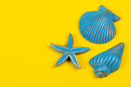 Shells and starfish on yellow background. sea summer vacation background