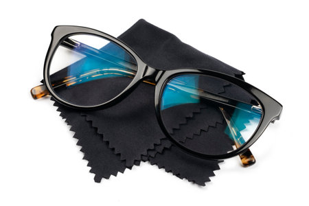 Glasses with black and tortoiseshell frames on black lens wipes