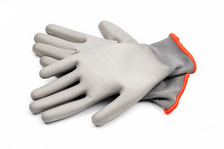 Gray textile work gloves with rubber isolated on white