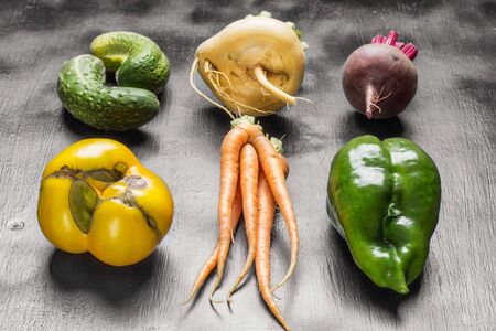 Set of fresh vegetables (beet, tomato,turnip,green pepper,cucumber) on black background.の写真素材