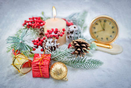 New Year's composition. New Year's wreath with burning candles, gifts, vintage watches in the...