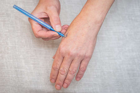 A cross on the arm as a keepsake for an elderly woman