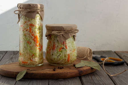 Homemade sauerkraut in a glass jar on a rustic background. Fermented productの写真素材