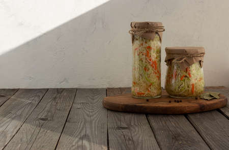 Homemade sauerkraut in a glass jar on a rustic background. Fermented productの写真素材