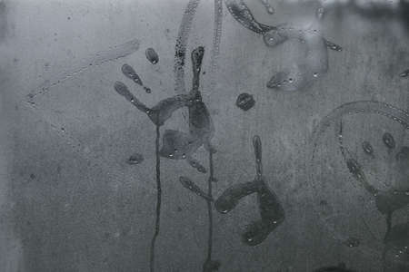 Children's handprints on the misted glass. To stay at home. Background. Insulation