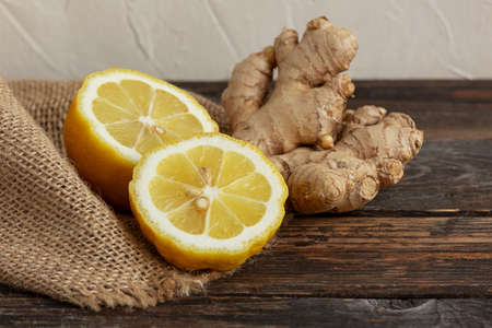 Lemon and ginger on a wooden background, Antiviral product, Herbal medicine, Healthy food.の写真素材
