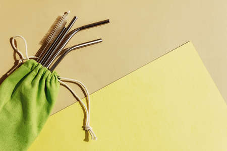 Reusable metal cocktail straws in storage bag. Zero waste concept.