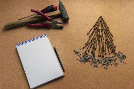 Spruce from self-tapping screws on a wooden background. Christmas renovation theme with place for text.の写真素材