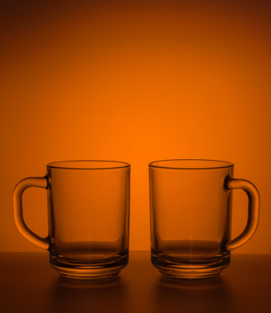 Still-life with tea mugs are not filled on colored background.の写真素材