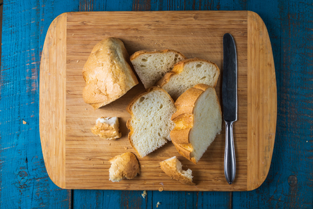 Flat lay view of Baked homemade white wheet bread on old blue wooden desk.