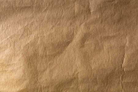 textured background with crumpled brown paper, flat lay view.の写真素材