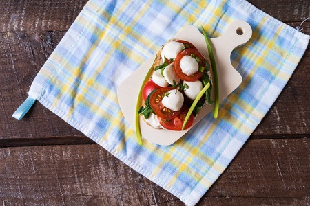 Variety of sandwiches or tapas with bread , cream cheese, vegetable and tasty toppings. Healthy food for lunch or breakfast. White background. Flat lay. Copy space for your text.の写真素材