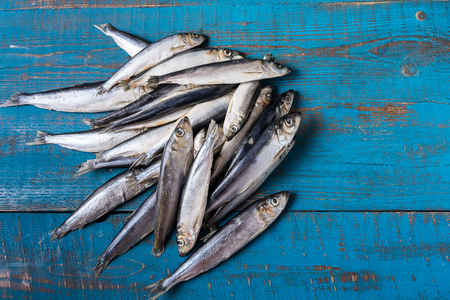 Rustic style. Fish pattern. Herring fish on an old blue wooden background, flat lay, copy space.の写真素材