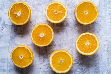 Healthy eating concept. Pattern with raw fresh orange citrus fruit. Flat lay, over white concrete background.の写真素材