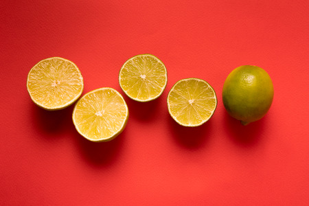 Healthy eating concept. Pattern with raw fresh lemon Citrus fruit . Flat lay, over red background, copy space.の写真素材
