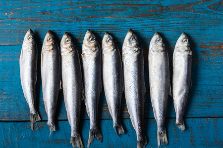 Rustic style. Fish pattern. Herring fish on an old blue wooden background, flat lay, copy space.の写真素材