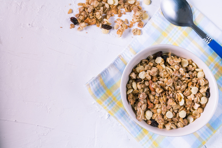 Bowl of organic granola with fresh berries and cashew nuts on white background flat lay and horizontal.の写真素材