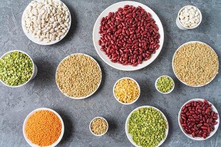 Top view of assortment of peas, lentils, beans and legumes over gray background.の写真素材