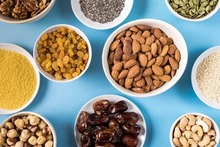 Top view the set of Superfoods in Bowls on blue Background.の写真素材