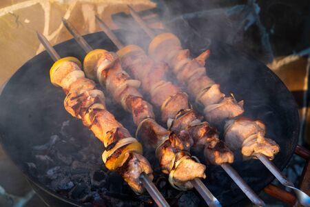 Hot Pork barbecue cooking on grill with spices, outdoor, spring.の写真素材