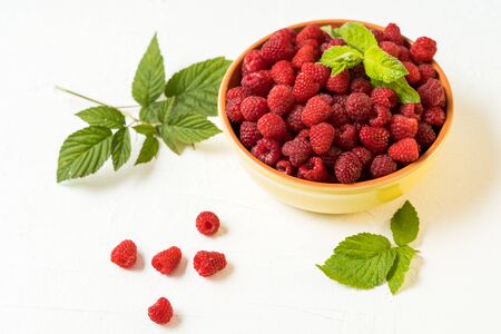 Red fresh ripe raspberry bowl. Summer concept. Flat lay with copy space.