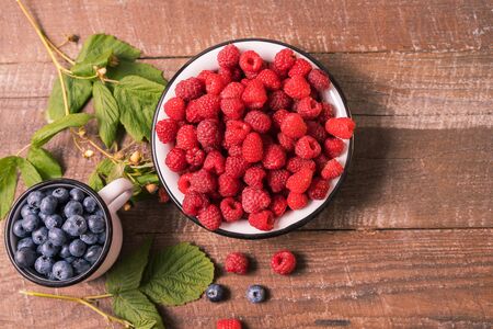 Red fresh ripe raspberry bowl. Summer concept. Flat lay with copy space.