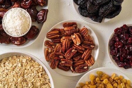 Ingredients for preparing Healthy organic energy balls- dates, dried apricot, oat flakes, raisin,...