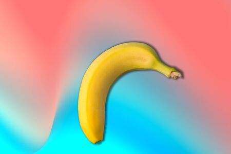 Creative minimal Flat lay of banana fruit over colorful background.の写真素材