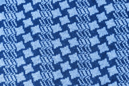 Color of the year 2020 concept. Flat lay Knitted Wool textured scarf toned in classic blue color.