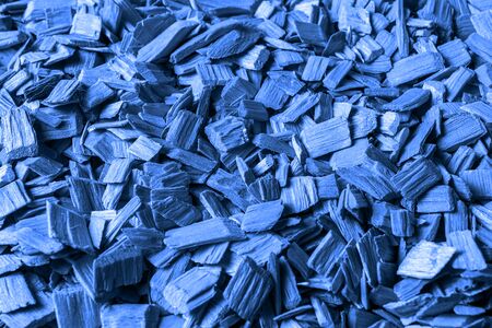 Flat lay Wood chips textured background, toned in trendy classic blue color.の写真素材