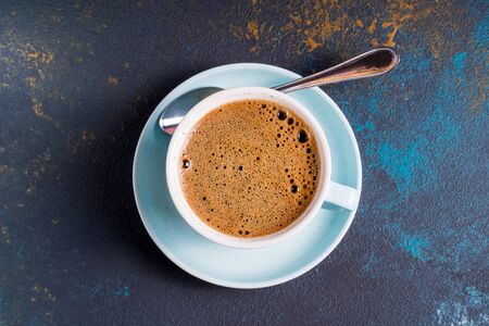 Black coffee with foam in a cup , on blue concrete background.,flat lay.の写真素材