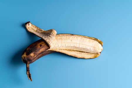 Overripe ugly rotten bananas on a blue background.の写真素材
