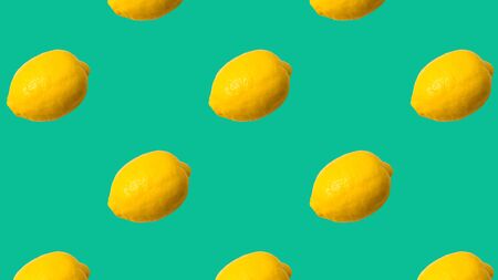 Seamless Pattern made with lemon fruit on aqua color background,panorama.の写真素材