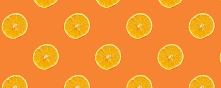 Seamless Pattern with lemon fruit slices on orange color background,panorama.の写真素材