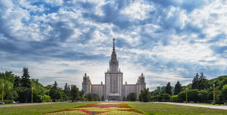 Moscow, Russia - June 15, 2020: the Moscow Lomonosov State University and the Wide flowerbed with flowers, horizontal shot.のeditorial素材
