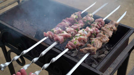 Raw Pork skewers on the grill in the garden of a country house.の写真素材